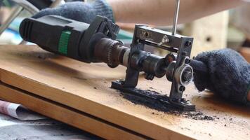 Man stripping large wires with machine to sell copper. video