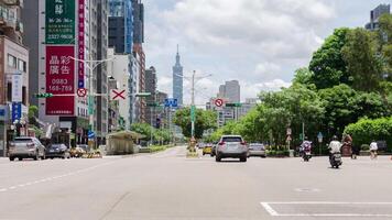 timelapse street view at intersection with pedestrian and cars traffic transportation surrounding with buildings and Taipei 101 highrise building landmark of Taipei video