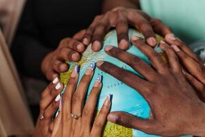 Close up of diverse teenagers' hands delicately exploring a globe, capturing the essence of curiosity and exploration in their tactile engagement with geographical knowledge photo