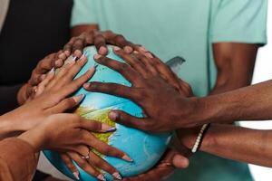 Close up of diverse teenagers' hands delicately exploring a globe, capturing the essence of curiosity and exploration in their tactile engagement with geographical knowledge photo