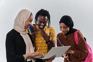 A group of students, including an African American student and two hijab-wearing women, stand united against a pristine white background, symbolizing a harmonious blend of cultures and backgrounds in photo