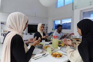 In the sacred month of Ramadan, a diverse Muslim family comes together in spiritual unity, fervently praying to God before breaking their fast, capturing a moment of collective devotion, cultural photo