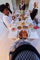 In the sacred month of Ramadan, a diverse Muslim family comes together in spiritual unity, fervently praying to God before breaking their fast, capturing a moment of collective devotion, cultural photo