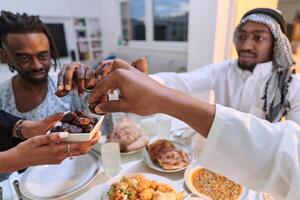 In a poignant close-up, the diverse hands of a Muslim family delicately grasp fresh dates, symbolizing the breaking of the fast during the holy month of Ramadan, capturing a moment of cultural unity photo