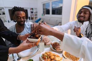 In a poignant close-up, the diverse hands of a Muslim family delicately grasp fresh dates, symbolizing the breaking of the fast during the holy month of Ramadan, capturing a moment of cultural unity photo