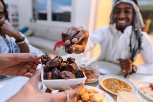 In a poignant close-up, the diverse hands of a Muslim family delicately grasp fresh dates, symbolizing the breaking of the fast during the holy month of Ramadan, capturing a moment of cultural unity photo