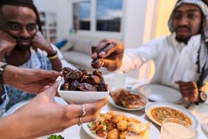In a poignant close-up, the diverse hands of a Muslim family delicately grasp fresh dates, symbolizing the breaking of the fast during the holy month of Ramadan, capturing a moment of cultural unity photo