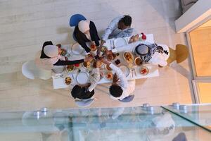 Top view of diverse hands of a Muslim family delicately grasp fresh dates, symbolizing the breaking of the fast during the holy month of Ramadan, capturing a moment of cultural unity, shared tradition photo