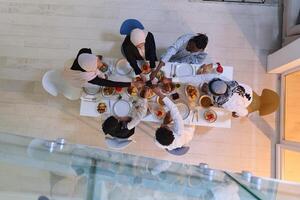 Top view of diverse hands of a Muslim family delicately grasp fresh dates, symbolizing the breaking of the fast during the holy month of Ramadan, capturing a moment of cultural unity, shared tradition photo