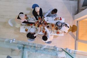 Top view of diverse hands of a Muslim family delicately grasp fresh dates, symbolizing the breaking of the fast during the holy month of Ramadan, capturing a moment of cultural unity, shared tradition photo