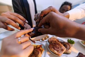 In a poignant close-up, the diverse hands of a Muslim family delicately grasp fresh dates, symbolizing the breaking of the fast during the holy month of Ramadan, capturing a moment of cultural unity photo