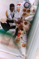 Top view of diverse hands of a Muslim family delicately grasp fresh dates, symbolizing the breaking of the fast during the holy month of Ramadan, capturing a moment of cultural unity, shared tradition photo