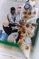 Top view of diverse hands of a Muslim family delicately grasp fresh dates, symbolizing the breaking of the fast during the holy month of Ramadan, capturing a moment of cultural unity, shared tradition photo