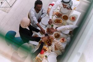 Top view of diverse hands of a Muslim family delicately grasp fresh dates, symbolizing the breaking of the fast during the holy month of Ramadan, capturing a moment of cultural unity, shared tradition photo