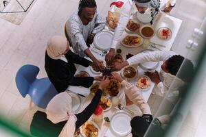 Top view of diverse hands of a Muslim family delicately grasp fresh dates, symbolizing the breaking of the fast during the holy month of Ramadan, capturing a moment of cultural unity, shared tradition photo