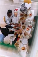 Top view of diverse hands of a Muslim family delicately grasp fresh dates, symbolizing the breaking of the fast during the holy month of Ramadan, capturing a moment of cultural unity, shared tradition photo