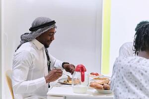A traditional and diverse Muslim family comes together to share a delicious iftar meal during the sacred month of Ramadan, embodying the essence of familial joy, cultural richness, and spiritual unity photo