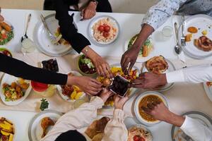 Top view of diverse hands of a Muslim family delicately grasp fresh dates, symbolizing the breaking of the fast during the holy month of Ramadan, capturing a moment of cultural unity, shared tradition photo