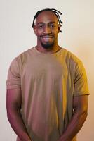 A charismatic and stylish African American man commands attention against a vibrant yellow gel background, showcasing his confident and contemporary fashion sense, radiating charm and sophistication photo
