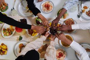 Top view of diverse hands of a Muslim family delicately grasp fresh dates, symbolizing the breaking of the fast during the holy month of Ramadan, capturing a moment of cultural unity, shared tradition photo
