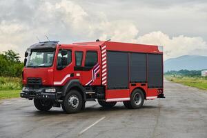 In this captivating scene, a state-of-the-art firetruck, equipped with advanced rescue technology, stands ready with its skilled firefighting team, prepared to intervene and respond rapidly to photo