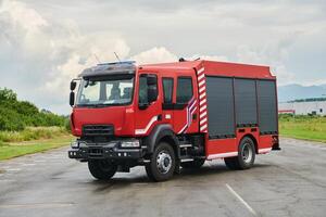 In this captivating scene, a state-of-the-art firetruck, equipped with advanced rescue technology, stands ready with its skilled firefighting team, prepared to intervene and respond rapidly to photo