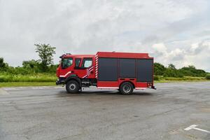 In this captivating scene, a state-of-the-art firetruck, equipped with advanced rescue technology, stands ready with its skilled firefighting team, prepared to intervene and respond rapidly to photo