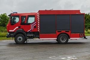 In this captivating scene, a state-of-the-art firetruck, equipped with advanced rescue technology, stands ready with its skilled firefighting team, prepared to intervene and respond rapidly to photo