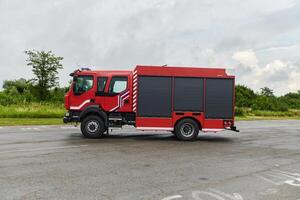 In this captivating scene, a state-of-the-art firetruck, equipped with advanced rescue technology, stands ready with its skilled firefighting team, prepared to intervene and respond rapidly to photo