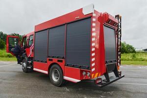In this captivating scene, a state-of-the-art firetruck, equipped with advanced rescue technology, stands ready with its skilled firefighting team, prepared to intervene and respond rapidly to photo