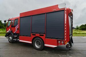In this captivating scene, a state-of-the-art firetruck, equipped with advanced rescue technology, stands ready with its skilled firefighting team, prepared to intervene and respond rapidly to photo