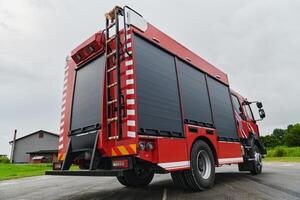 In this captivating scene, a state-of-the-art firetruck, equipped with advanced rescue technology, stands ready with its skilled firefighting team, prepared to intervene and respond rapidly to photo