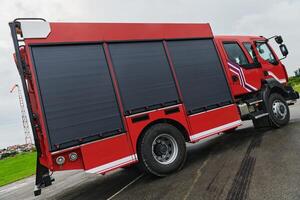 In this captivating scene, a state-of-the-art firetruck, equipped with advanced rescue technology, stands ready with its skilled firefighting team, prepared to intervene and respond rapidly to photo