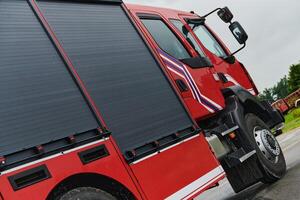 In this captivating scene, a state-of-the-art firetruck, equipped with advanced rescue technology, stands ready with its skilled firefighting team, prepared to intervene and respond rapidly to photo