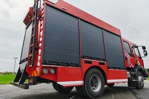 In this captivating scene, a state-of-the-art firetruck, equipped with advanced rescue technology, stands ready with its skilled firefighting team, prepared to intervene and respond rapidly to photo