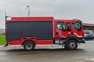 In this captivating scene, a state-of-the-art firetruck, equipped with advanced rescue technology, stands ready with its skilled firefighting team, prepared to intervene and respond rapidly to photo