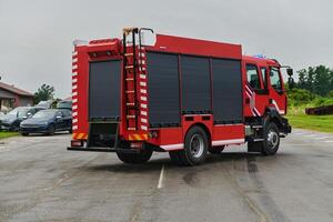 In this captivating scene, a state-of-the-art firetruck, equipped with advanced rescue technology, stands ready with its skilled firefighting team, prepared to intervene and respond rapidly to photo