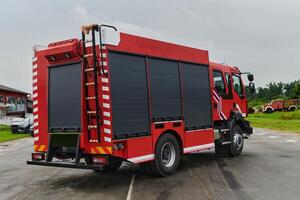 In this captivating scene, a state-of-the-art firetruck, equipped with advanced rescue technology, stands ready with its skilled firefighting team, prepared to intervene and respond rapidly to photo