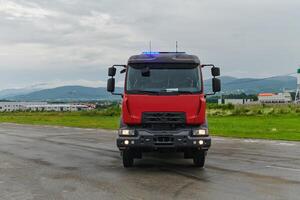 In this captivating scene, a state-of-the-art firetruck, equipped with advanced rescue technology, stands ready with its skilled firefighting team, prepared to intervene and respond rapidly to photo