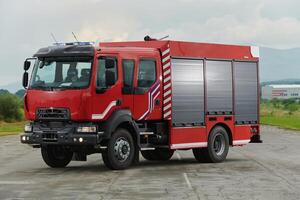 In this captivating scene, a state-of-the-art firetruck, equipped with advanced rescue technology, stands ready with its skilled firefighting team, prepared to intervene and respond rapidly to photo