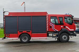In this captivating scene, a state-of-the-art firetruck, equipped with advanced rescue technology, stands ready with its skilled firefighting team, prepared to intervene and respond rapidly to photo