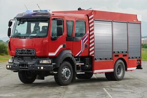 In this captivating scene, a state-of-the-art firetruck, equipped with advanced rescue technology, stands ready with its skilled firefighting team, prepared to intervene and respond rapidly to photo