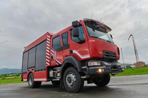 In this captivating scene, a state-of-the-art firetruck, equipped with advanced rescue technology, stands ready with its skilled firefighting team, prepared to intervene and respond rapidly to photo