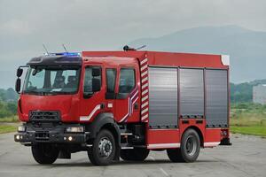 In this captivating scene, a state-of-the-art firetruck, equipped with advanced rescue technology, stands ready with its skilled firefighting team, prepared to intervene and respond rapidly to photo