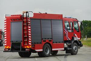 In this captivating scene, a state-of-the-art firetruck, equipped with advanced rescue technology, stands ready with its skilled firefighting team, prepared to intervene and respond rapidly to photo