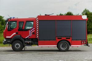 In this captivating scene, a state-of-the-art firetruck, equipped with advanced rescue technology, stands ready with its skilled firefighting team, prepared to intervene and respond rapidly to photo