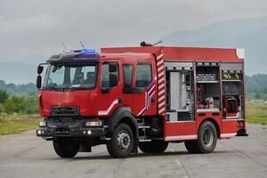 In this captivating scene, a state-of-the-art firetruck, equipped with advanced rescue technology, stands ready with its skilled firefighting team, prepared to intervene and respond rapidly to photo