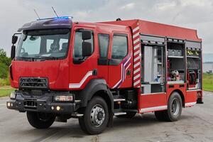 In this captivating scene, a state-of-the-art firetruck, equipped with advanced rescue technology, stands ready with its skilled firefighting team, prepared to intervene and respond rapidly to photo