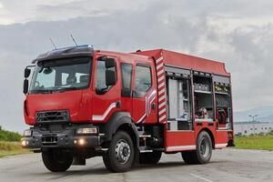 In this captivating scene, a state-of-the-art firetruck, equipped with advanced rescue technology, stands ready with its skilled firefighting team, prepared to intervene and respond rapidly to photo