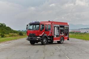 In this captivating scene, a state-of-the-art firetruck, equipped with advanced rescue technology, stands ready with its skilled firefighting team, prepared to intervene and respond rapidly to photo
